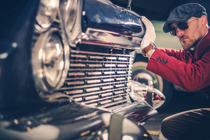 Classic Car Passionate. Caucasian Collector Looking For the New Vintage Car For His Collection. History of American Transportation Concept Photo.