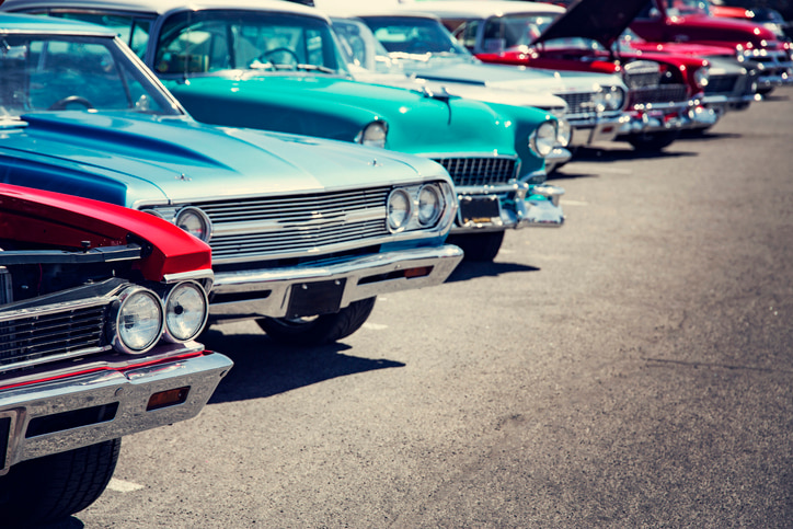 Vintage and classic cars lined up in an outdoor space